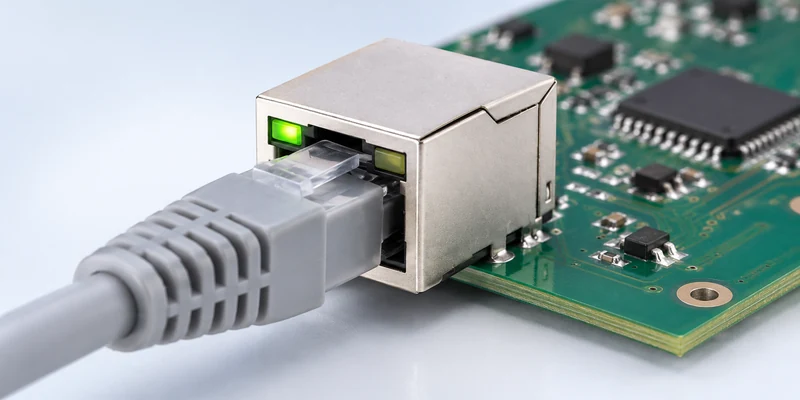Magnetic RJ45 connector with an Ethernet cable and a green status LED on a PCB