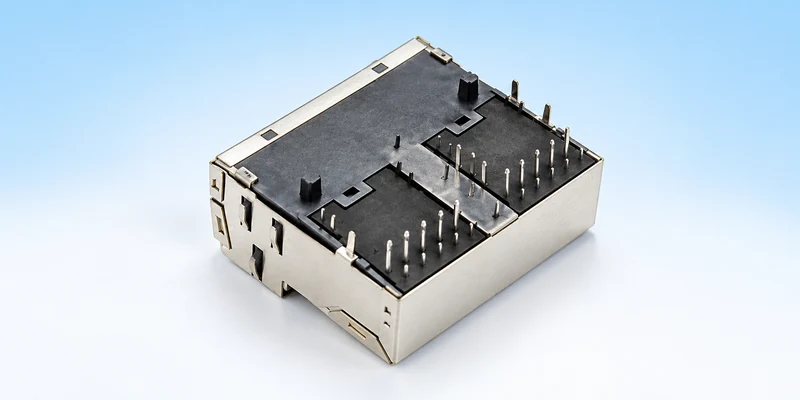 Underside view of a two-port shielded MagJack showing terminal groups and shield retention legs